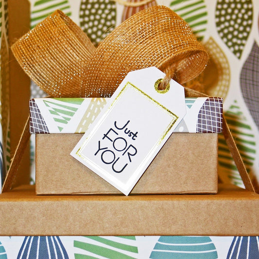 Image of gifts with beautiful green, blue, gold and brown paper gift wrapping. Signifying Luxe & Humble physical gift vouchers. 