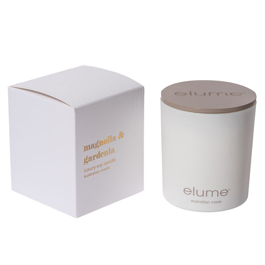 Elume Magnolia & Gardenia Soy Candle Box, sitting beside the Candle with its lid on.