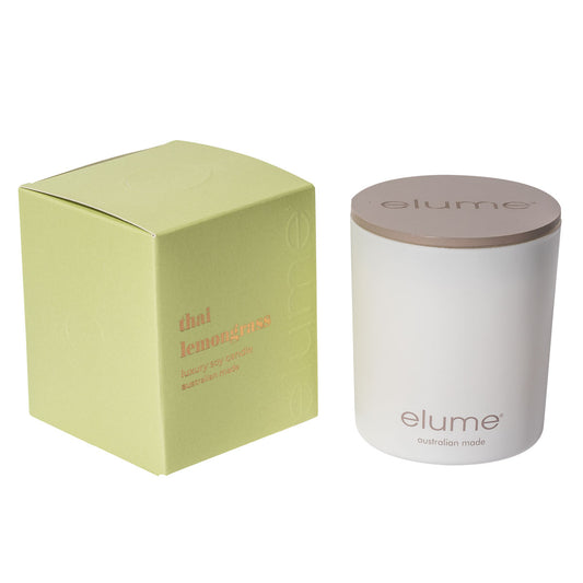 Elume Thai Lemongrass Soy Candle Box, sitting beside the Candle with its lid on.